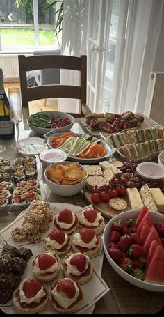 a table filled with lots of food and desserts