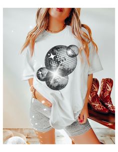 Comfort Colors Retro Disco Ball Oversized Tee Perfect for a Brides Last Disco Themed Bachelorette Party Or Any Fun Club Tee Machine wash inside out with like colors. Tumble dry on low to medium heat. Do not iron directly on image. Please refer to size chart for reference before purchasing. If you want an oversized fit, go up 1-2 sizes. Please feel free to message with any questions. Please note, since items are made to order, we do not accept cancellations, returns or exchanges. Please make sure all sizing and shipping information is correct before placing an order! Mockups are used for demonstration purposes only, and the final product may vary slightlty in color and placement due to printing and computer monitors. Summer Disco Tops With Crew Neck, Summer Disco Top With Crew Neck, Disco Style Cotton Short Sleeve Tops, Disco Style Cotton Top With Short Sleeves, Disco Style Crew Neck Tops With Letter Print, Disco Style White Top With Graphic Print, Oversized Casual Party Top, Disco Style Graphic Print Short Sleeve Top, White Disco Style Tops With Graphic Print