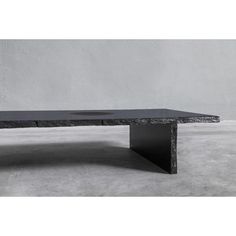 a black table sitting on top of a cement floor