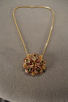 I am offering this fabulous vintage yellow gold tone necklace. This piece is truly gorgeous, and it has the following features:  * beautiful vintage necklace * rhinestone * floral design * glass beads * dangle * 16 inches in length This is a fantastic and classic piece. There is tons of sparkle and shine with this piece. It will beautifully complement your upcoming fashion season. Buyer pays all shipping and handling. Vintage Jeweled Necklaces For Anniversary, Costume Rhinestone Necklace For Gifts, Antique Rhinestone Necklace For Gift, Luxury Art Deco Yellow Gold Necklace, Vintage 14k Gold-tone Necklace, Vintage Gold Rhinestone Necklace With Sparkling Stones, Antique Rhinestone Necklace Gift, Vintage Jeweled Rhinestone Necklace Gift, Vintage Gold Jeweled Rhinestone Necklace