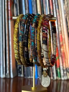 Stack up on these colorful & bold boho bangles!  I wrap each bracelet by hand with unique upcycled sari silk and finish with a wire wrap to secure.  Add vintage kuchi coin charms to a few or all to complete the look, These bracelets are a super simple and lightweight for easy, comfortable wear. Select one or mix and match to create your own personalized set! ★ Handmade ★ Upcycled Sari Silk ★ Non-Tarnish Wire ★ Vintage Kuchi Coin Charm ★ 65mm inner diameter ✉ Message for Custom Requests ✈ Free Shipping  ♥ Handmade  💌 Gift Wrapped Handmade Bohemian Braided Bracelet For Festivals, Bohemian Hand-wrapped Bracelets For Festivals, Adjustable Bohemian Braided Bracelets For Festivals, Handmade Bohemian Bangle As Gift, Bohemian Braided Bracelets For Festivals, Adjustable Bohemian Braided Bracelet For Festivals, Bohemian Handmade Friendship Bracelets For Festivals, Multicolor Bohemian Bracelets For Festivals, Bohemian Multicolor Bracelets For Festivals