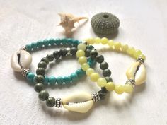 Bracelets are elastic and made of 6mm gemstone (natural serpentine, natural lemon jade, or synthetic turquoise), a natural cowrie shell (22 - 26 mm) and Tibetan style beads (all lead- and cadmium-free, rustless).  Size guide: To order the right size, please measure your wrist. Wrap a measuring tape around your wrist and read the measurement.  Make sure not to wrap the tape too tightly or too loosely for the best measurement. If you do not have a measuring tape, use a piece of string to wrap arou Cowrie Shell Bracelet, Beaded Shell, Lava Rock Bracelet, Wrist Wrap, Beach Boho, Shell Bracelet, Hippie Jewelry, Cowrie Shell, Measuring Tape