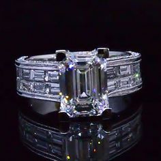 an emerald cut diamond ring with baguetts on the sides