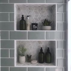 three white shelves with plants and soaps on them in a bathroom wall tile pattern