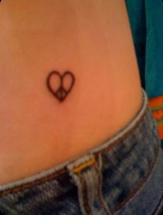 a small heart tattoo on the stomach