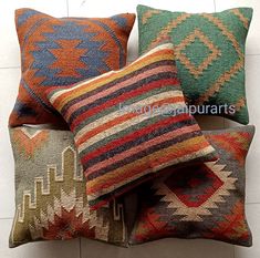 four colorful pillows stacked on top of each other