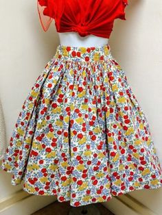 ALL SALES FINAL. PLEASE ASK QUESTIONS PRIOR TO PURCHASE. THANK YOU. This is a true vintage 1950s/50s tulip/floral print cotton skirt. Pin up/ Rockabilly style. This is a handmade skirt. --**LISTING IS FOR SKIRT ONLY.--** The skirt is made of cotton with a print of tulips, daisies and forget me nots. Skirt zips up the back with a functioning metal zipper. There are two red buttons at the back waist band that do not match, one is a replacement.The skirt is pleated and full, but not a circle skirt. Fitted Skirt In 1950s Style For Summer, Fitted 1950s Style Summer Skirt, Fitted Vintage Mini Skirt, Vintage Skirt For Garden Party, Vintage Fitted Cotton Skirt, Spring Vintage Skirt For Vintage Fashion, Vintage Fashion Skirt For Spring, Spring Vintage Fashion Skirt, Vintage Cotton Pleated Skirt