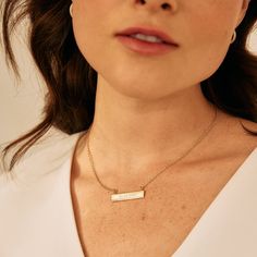 Commemorate a special memory with the Date Bar Necklace. This bar necklace will be custom engraved with your date of choice and is available in rose gold, yellow gold or rhodium-plated finishing options. A perfectly thoughtful gift for birthdays, anniversaries, and graduations. Available in 14k gold plated, rhodium plated or 14k rose gold plated brass Bar size: 1 1/4" by 1/4" 16" cable chain with 2" extender Lobster claw closure With engraving this item is FINAL SALE SKU: BYN1078 Elegant Engraved Bar Necklace, Classic Anniversary Name Necklace With Delicate Chain, Classic Name Necklace With Delicate Chain For Anniversary, Elegant Engraved Name Necklace For Personalized Gift, Rose Gold Name Necklace With Delicate Chain For Anniversary, Elegant Rectangular Pendant Name Necklace For Anniversary, Personalized Bar Necklace As Gift, Elegant Rose Gold Bar Necklace For Gift, Minimalist Rose Gold Charm Necklace For Anniversary