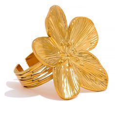 This ring showcases delicate floral details that add a touch of nature-inspired beauty to your look. The PVD gold plating ensures a lasting, lustrous finish, making it a timeless accessory for both casual and formal occasions. The ring size is adjustable for your convenience! 🎁 Perfect for gifting - let me know if it's a gift to someone special and I will add a cute velvet pouch to your order for free! ✨ Stainless Steel with PVD gold plating (4 microns) ✨ Ring size 7 and resizable ✨ Featuring big flower ✨ Elegant and luxurious accessory Steel Flowers, Gold Color Ring, Stainless Steel Accessories, Trendy Fashion Jewelry, Ringe Gold, Charm Rings, Big Flowers, Jewelry Stand, Timeless Accessories