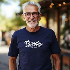 Celebrate your amazing grandpa with this "World's Best Grandpa" T-Shirt featuring "Est. 2024". This shirt is the perfect gift for Grandfather's Day, birthdays, or family reunions. The design can be customized by changing the Est. year, making it a unique and personalized gift. Show your love and appreciation for your grandpa with this special tee! Product Features: Fabrication: 100% combed, ring-spun cotton - Light fabric (4.3 oz/yd² (146 g/m²)) Seams: Side-seamed Fit: Premium Fit Sizing: Runs b Best Grandpa, T Shirt World, Family Reunions, Your Amazing, Family Reunion, Cotton Lights, World's Best, Light Fabric, Product Features