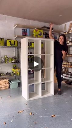 a woman standing in front of a book shelf