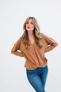 Waffle knit fabric offers the best of both worlds - warm enough to protect you against brisk weather, and cool enough not to sweat if the sun starts to shine. Button details and a slouchy dropped shoulder complete this adorable top!  Details: Small: 44” bust, 42” waist Model wears a size small