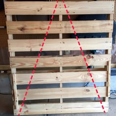 a wooden pallet with red tape on the bottom and sides that are connected to each other