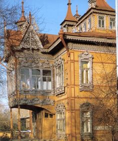 an old wooden house with many windows and balconies