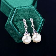 Romantic and elegant, this glowing pearl necklace and earrings set can complete the most sophisticated of bridal looks. Rhodium plated for a flawless finish which perfectly enhances the intricate detailing and conveys a modern take on old elegance, this exquisite jewelry set features iridescent pearls and cubic zirconia. Necklace: The pendant measures 1.5" (approx. 3.8cm), and features 0.4" (approx. 1.2cm) pearls. The pendant hangs from a delicate chain, 16" (approx. 40.6cm) long, with a 2" (app Pearl Drop Earrings Wedding, Pearl Necklace And Earrings, Iridescent Pearl, Pearl Jewelry Wedding, Cubic Zirconia Jewelry, Necklace And Earrings Set, Cz Jewelry, Pearl Types, Pearl Wedding