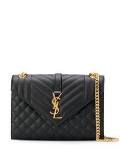 Black calf leather Cassandra quilted shoulder bag from Saint Laurent featuring signature YSL logo plaque, gold-tone hardware, quilted finish, envelope design, leather and chain-link shoulder strap, front flap closure, magnetic fastening, main compartment and internal slip pocket. | Saint Laurent Cassandra quilted shoulder bag Pink Duffle Bag, Embroidered Shoulder Bag, Quilted Shoulder Bag, Ysl Logo, Oversized Tote Bag, Yves Saint Laurent Bags, Quilted Purses, Black Leather Crossbody Bag, Envelope Design