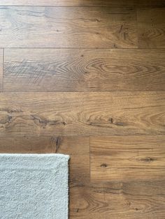 wood flooring with white rug on top