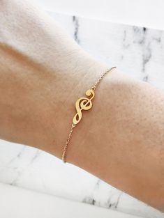 "14K 9K Gold Music Note Bracelet, Treble Clef Charm Bracelet, Dainty Music Note Bracelet, Solid Gold Bracelet, Musician Gift, Music Lover Gift, Christmas Gift, FREE EXPRESS SHIPPING Beautiful and delicate bracelet with a treble clef/note charm made in 14K or 9K solid gold. \"Music gives a soul to the universe, wings to the mind, flight to the imagination and life to everything.\" -- Plato Whisper...I love Music! -------------------------------------------------- D E T A I L S 14K Solid Gold or 9 Music Note Bracelet, Music Obsession, Music Bracelet, Music Symbol, Armband Tattoos, Dream Rings, Lover Jewelry, Lovers Bracelet, Solid Gold Bracelet