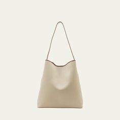 Aesther Ekme "Sac" hobo bag in cotton and faux leather (polyurethane) Shoulder strap  Open top with magnetic closure  Approx. 14.6"H x 14.2"W x 4.3"D Made in Spain Classic Hobo Bag With Adjustable Strap For Shopping, Modern Large Capacity Bucket Hobo Bag, Chic Shoulder Hobo Bag For Errands, Beige Bucket Baguette Bag For Everyday Use, Beige Baguette Bag With Leather Handles For Daily Use, Everyday Beige Bucket Baguette Bag, Bucket Hobo Bag With Removable Pouch For Errands, Cream Shoulder Bucket Bag For Errands, Beige Hobo Bag With Adjustable Top Handle