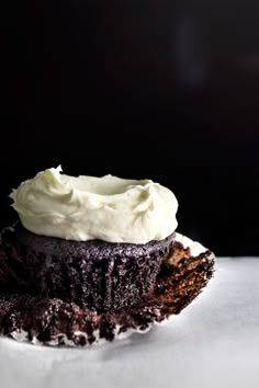 a chocolate cupcake with whipped cream on top