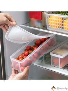 two people grabbing food out of an open refrigerator