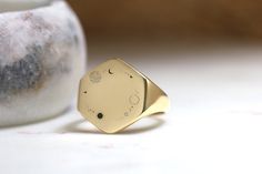 Embark on a cosmic journey with this exquisite 14k Gold Hexagon Signet Ring, adorned with an intricately engraved space pattern featuring stars. This celestial-inspired piece captures the wonder of the night sky and the infinite beauty of the cosmos. Crafted from luxurious 14k gold in a unique hexagon shape, the ring is a testament to the elegance and mystery of the universe. Perfect for astronomy enthusiasts or anyone drawn to celestial motifs, this ring blends sophisticated design with the awe Cosmos Jewelry, Celestial Motifs, Cosmic Ring, Dna Jewelry, Stars Ring, Ring Hexagon, Space Pattern, Hexagonal Ring, Signet Rings