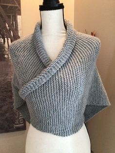 Outlander's heroine, Claire, has become famous for her shawls. This shawl or Sontag, as crossover shawls were known as, is a simple workday shawl.  This one is hand-knit in a pearl gray blended wool. It can be pinned or tied in the back, although Claire often sticks the ends into a belt in the back. Pearl Gray, Triangle Shawl, Triangle Shawls, Pearl Grey, Shawls And Wraps, Outlander, Crossover, Hand Knitting, Scarf Accessory