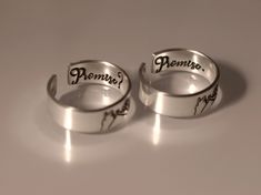 This Promise? Promise. Pinky Promise Ring Set is the perfect way to make a special vow to someone you love. Crafted from quality materials, the set features two matching rings, making it ideal for couples who want to express their commitment to one another. Show your devotion with this timeless pinky promise ring set. Product Details: Materials: Aluminum, Sterling Silver, Fine Silver, 14k Gold Filled Color: Silver, Gold, Rose Gold Size: 6mm Two Matching Rings You will receive two hand-stamped ri Couples Sterling Silver Jewelry For Promise, Adjustable Sterling Silver Wedding And Promise Rings, Engraved Adjustable Couple Promise Rings, Adjustable Engraved Promise Ring, Sterling Silver Personalized Rings For Proposal, Adjustable Sterling Silver Couple Rings For Proposal, Adjustable Personalized Rings For Proposal, Personalized Adjustable Ring For Proposal, Personalized Adjustable Proposal Ring