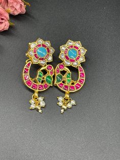 We bring beautiful Jewelry sure to elevate any look! Kindly pay attention to all photos and video and ask questions about the item prior to ordering. Bollywood Style Multicolor Peacock Jhumkas, Festive Multicolor Chandbali Pearl Earrings, Multicolor Peacock Design Danglers For Festivals, Traditional Peacock Design Earrings For Festivals, Multicolor Kundan Jhumkas With Peacock Design, Green Peacock Design Chandbali Jhumkas, Multicolor Peacock Design Danglers For Wedding, Traditional Bridal Earrings With Peacock Design For Festivals, Red Peacock Design Earrings For Celebration