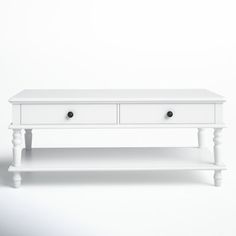 a white coffee table with two drawers on it