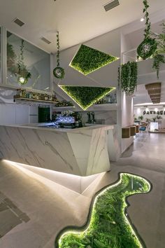 a kitchen with plants growing on the walls and floor, along with an island in the middle