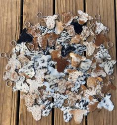 a bunch of different colored hair clips on top of a wooden table