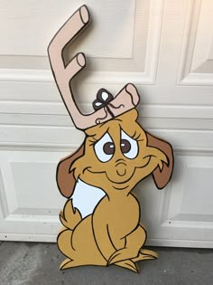 a cardboard cutout of a dog with a letter e on it's head