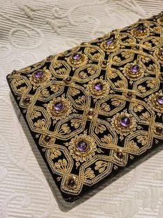 "Absolutely exquisite elegant evening bag. Embroidered best-quality black velvet. The geometric pattern is hand embroidered with gold metallic thread.  Amethyst and garnet genuine semi-stones add this special rich jewelry look.  Snap closure. Very elegant back strap. Size: 8\" x 5\" Perfect condition. Excellent gift. FREE SHIPPING Thank you for visiting my store. You can also visit my AmazingClosetShop or http://jewelryandclothing.net/ Please read \"The Private Policy\"" Hand Embellished Black Evening Bag, Black Hand Embellished Evening Bag, Elegant Hand Embellished Black Bag, Elegant Black Hand-embellished Bag, Elegant Black Hand-embellished Clutch, Elegant Black Hand Embellished Clutch, Luxury Hand Embellished Black Evening Bag, Luxury Hand-embellished Black Evening Bag, Luxury Black Hand Embellished Evening Bag