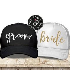 two hats with the words groom and bride on them sitting next to each other in front of a wooden table