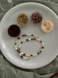 a white plate topped with different types of beads