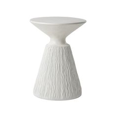 a white vase sitting on top of a table