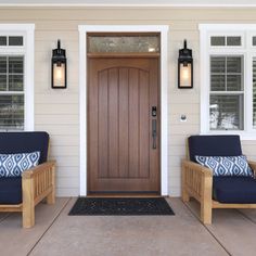 two chairs sitting on the front porch of a house next to a door with windows