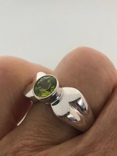 Rich bright Peridot green ring Sterling silver Tarnished with age, can be polished up. Size 7 can be sized by my jeweler. His service charge is $10-$20 All rings are shipped free in the US in a nice gift box. Check out our over a THOUSAND great reviews Engraving is $4 per letter and is not always perfect depending on the piece. It can take a few days if the jeweler is busy. This is payable to Paypal Judithsltd@gmail.com Green Sterling Silver Solitaire Ring, Green Solitaire Sterling Silver Ring, Lime Green Sterling Silver Rings As Gift, Lime Green Sterling Silver Rings For Gift, Green Sterling Silver Open Ring, Silver Peridot Rings With Polished Finish, Green Peridot Rings With Round Stone, Green Peridot Ring With Round Stone, Modern Sterling Silver Green Rings