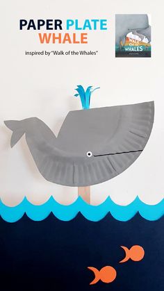 a paper plate whale on a stick in the water