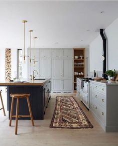 a kitchen with an area rug on the floor