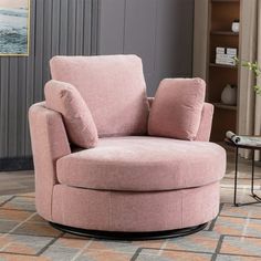 a pink chair sitting on top of a rug