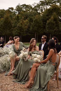 the bridesmaids are sitting in chairs with their bouquets