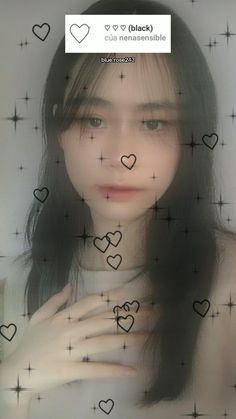 a woman with long black hair and hearts drawn on her face