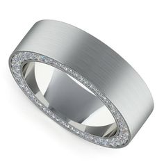 a white gold wedding band with pave set diamonds on the outside and inlays