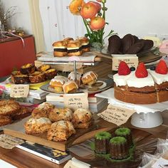 a table topped with lots of different types of cakes and pastries next to each other