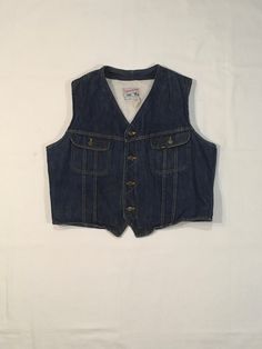 "vintage jean vest Lee Storm Rider made in USA Union made label in pocket, United Garment Workers of America 242 dark denim sherpa lining button up top button flap breast pockets side waist adjustable cinches w/cat eye concave black buttons good vintage condition, light wear light stains, fade, fray size label unreadable, see below measures, lying flat, shoulder-17\" chest-24\" hem-23\" length-25\"" Retro Dark Wash Cotton Denim Vest, Fitted Vintage Denim Vest For Winter, Vintage Denim Vest In Medium Wash For Winter, Fitted Vintage Denim Vest With Snap Buttons, Vintage Sleeveless Denim Outerwear, Vintage Sleeveless Denim Jacket With Pockets, Vintage Fitted Dark Wash Vest, Vintage Dark Wash Denim Vest, Vintage Denim Vest With Button Closure