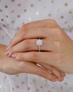 a woman's hand with a diamond ring on it