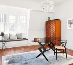 a living room with white walls and wooden floors