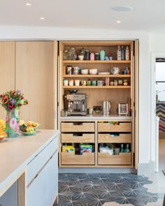 a kitchen with wooden cabinets and drawers filled with food on top of counter tops next to an oven